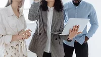 The Benefits Package Your Best Technicians Are Quietly Comparing You Against Three people looking at a laptop.