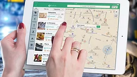 Are “Emergency” Jobs Costing You Money? Rethinking Dispatch Decisions A woman using an iPad with a map.