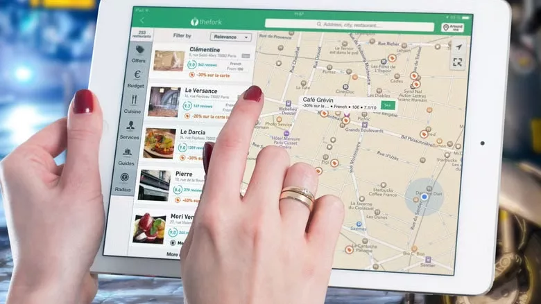 A woman using an iPad with a map.