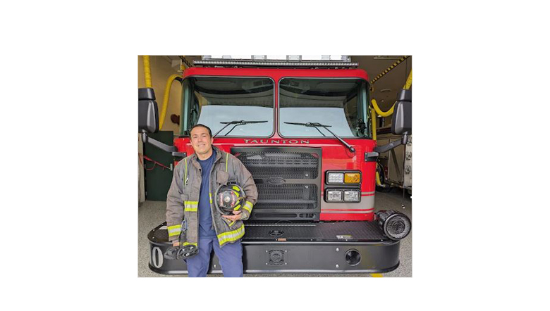 Jesse Correira in front of a firetruck. 