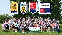 The AD team pictured with the logos for several workplace awards. 