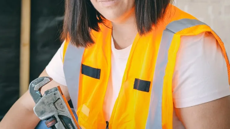 A contractor holding a tool.