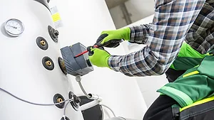 Large Residential Water Heating Boiler Maintenance Performed by Professional HVAC Technician Large Residential Water Heating Boiler Maintenance Performed by Professional HVAC Technician