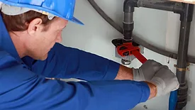 Plumber working on pipe 