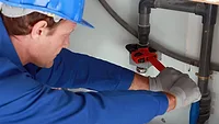 Plumber working on pipe Plumber working on pipe
