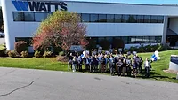 Watts Celebrates 10 Years of Training and Education Students posing outside of Watts' training center.