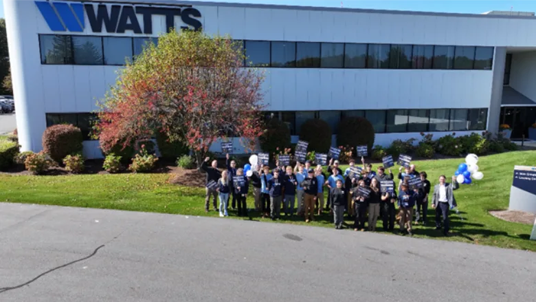 Students posing outside of Watts' training center.