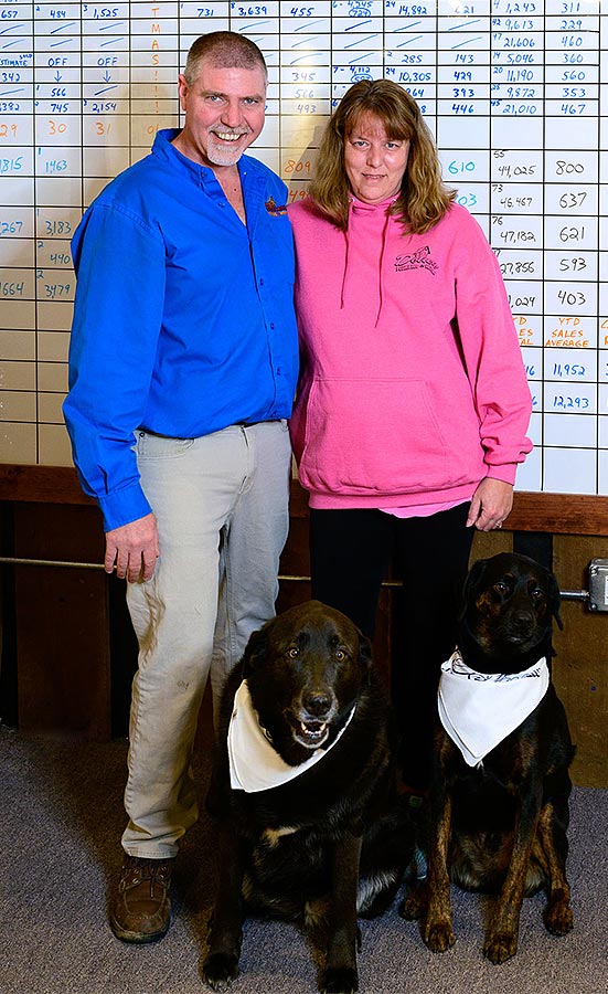 Larry and Kim Shoemaker with their office dogs.