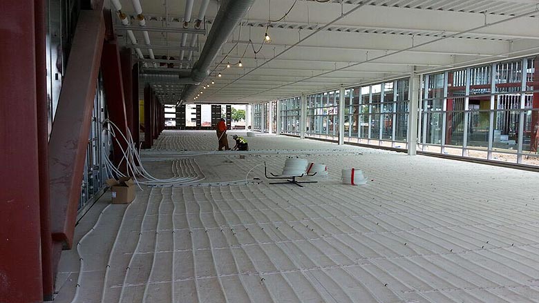 Installers work with Wirsbo hePEX Tubing Radiant Rollout Mat