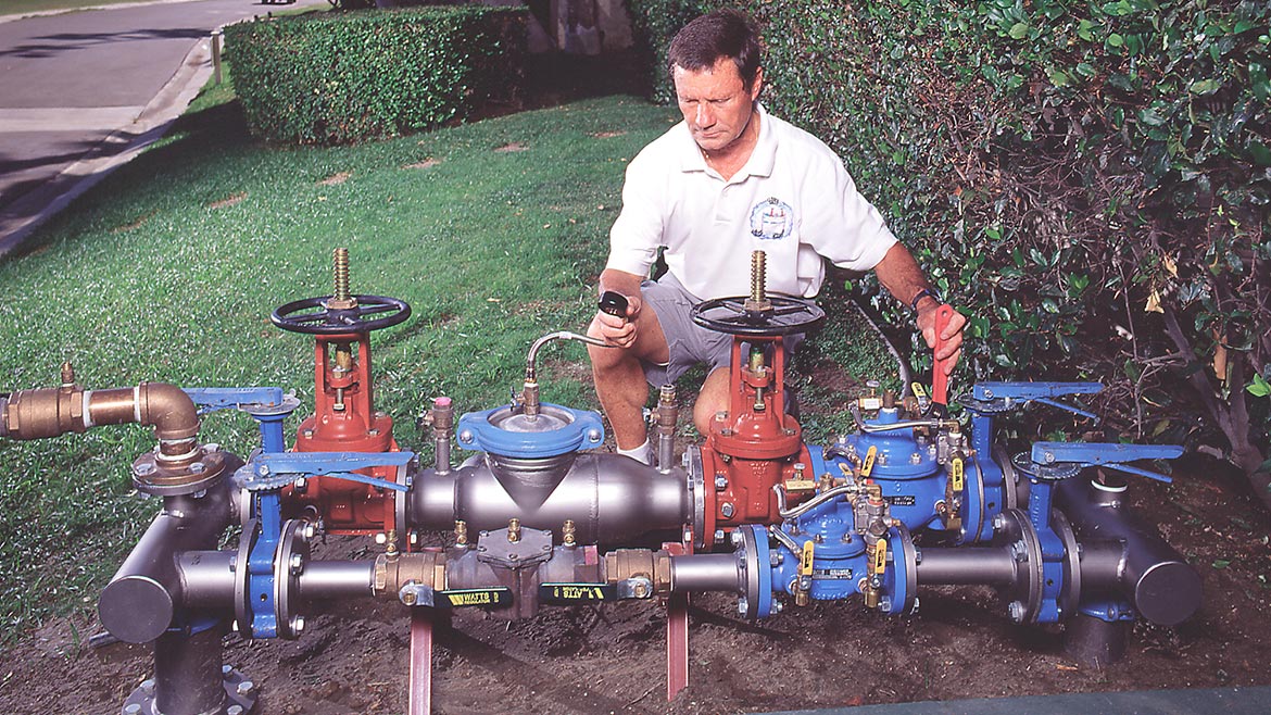 Bernie Clarke, Clarke Sales, adjusts a pilot-operated pressure reducing valve
