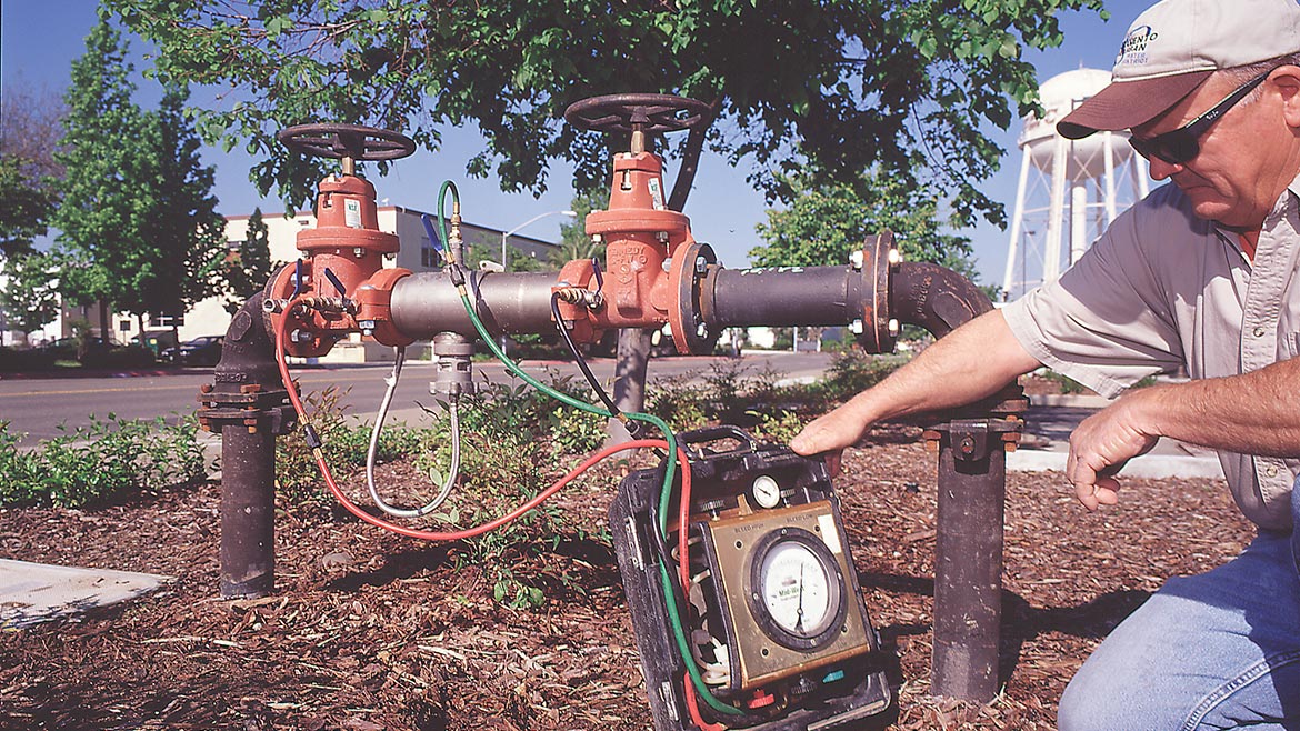 A backflow technician tests an RPZ