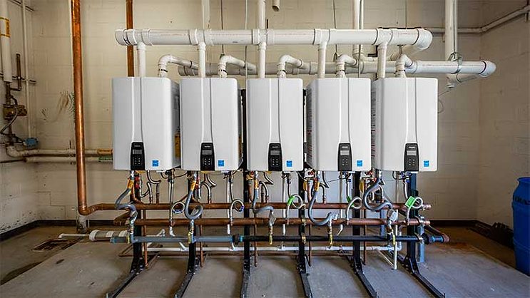 Tankless water heaters provide on-demand hot water, energy savings for high  school fieldhouse | Plumbing u0026 Mechanical