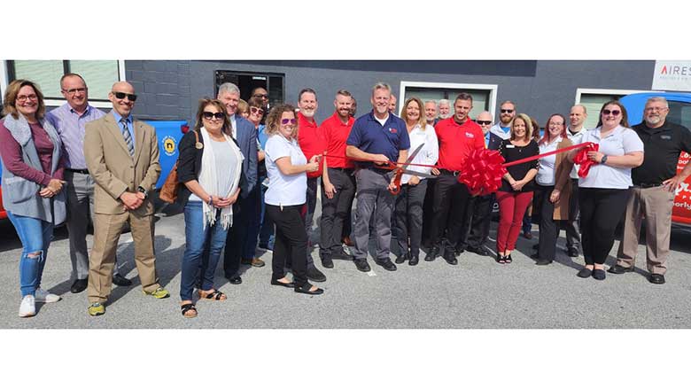 Ray Bramble cuts the ribbon during the grand opening ceremony