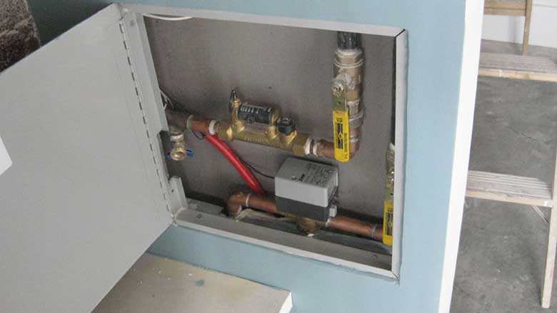 A balancing valve and zone valve access panel