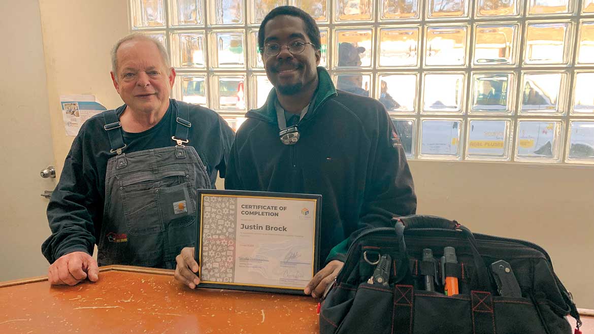 04 PM 1223 Nextech Thornton and Grooms. Warner Super Service Plumbing Apprentice Justin Brock posing with certificate of completion.