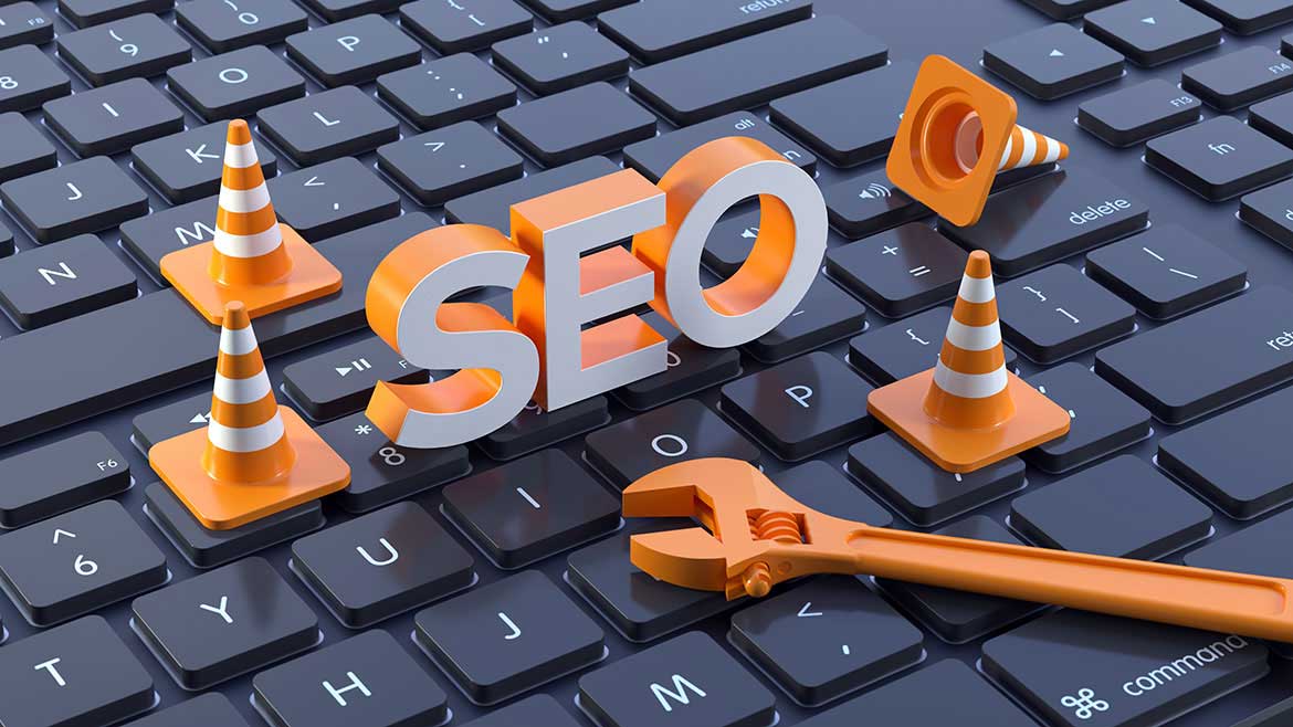 PM 0124 Guest Editorial Jason Mudd opening image of SEO letters, traffic cones and wrench on top of a keyboard.