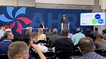 AHR Expo feature 2023 AHR Expo in Atlanta attendees sit in on exhibitor presentation.
