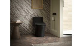 02 PM Feb 2024 KBIS Product Preview Kohler PureWash E930 bidet toilet, an elongated bidet seat, shown here in black, in a bathroom.