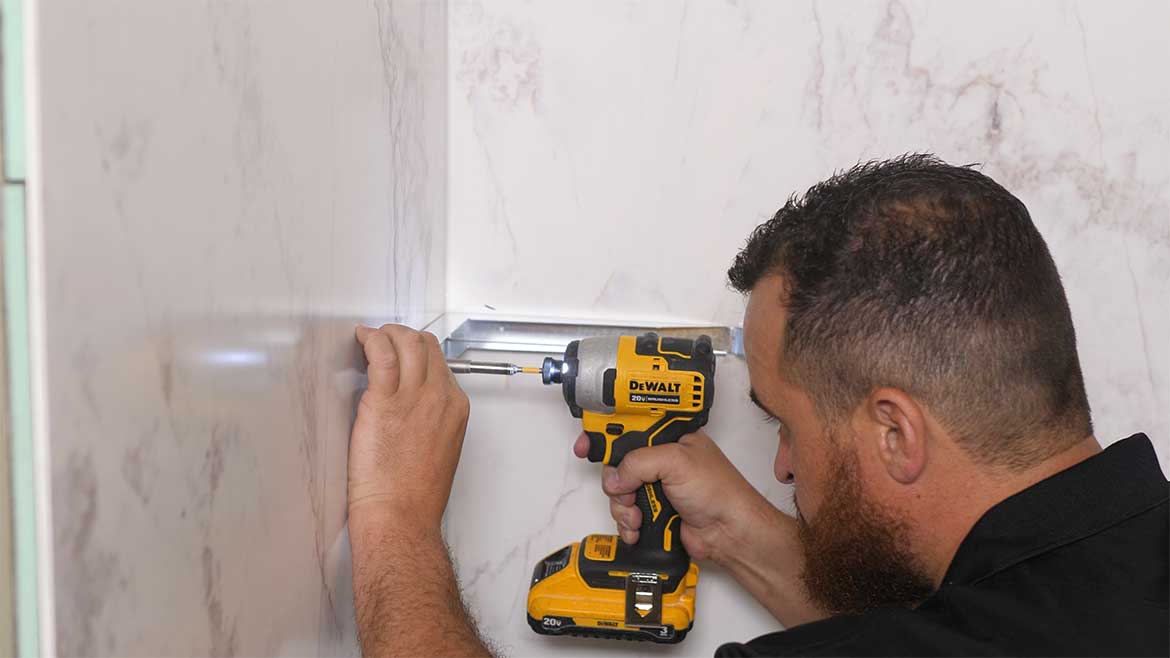Contractor using a drill in shower