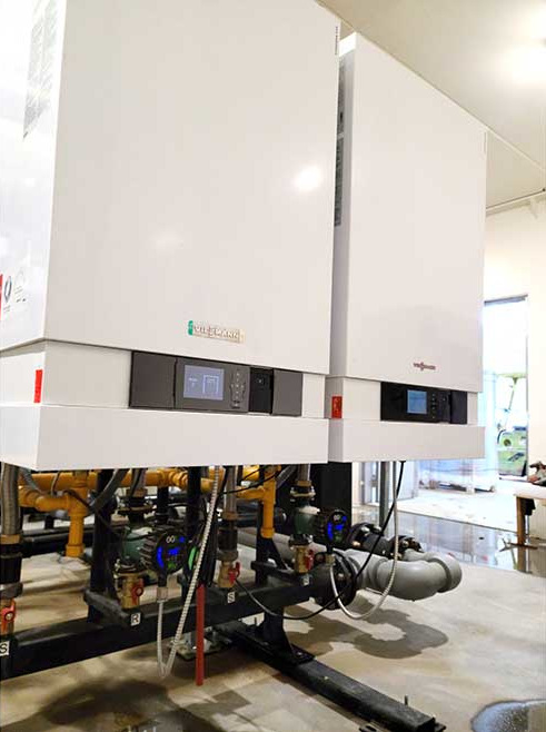 Two of the four cascaded boilers in the mechanical room of the equipment shop.