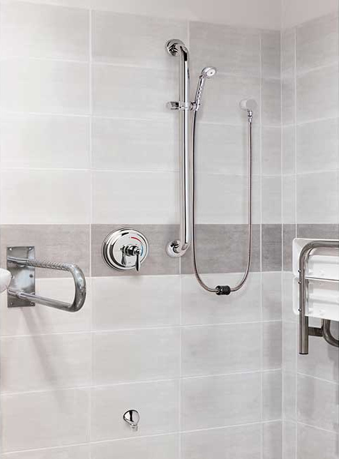 Interior of hospital patient bathroom with ligature prevention faucets.