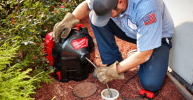 Worker using the Milwaukee Tool SWITCH PACK drain cleaner