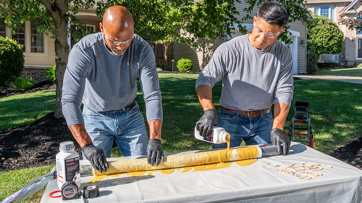 Two workers using a patch tool kit