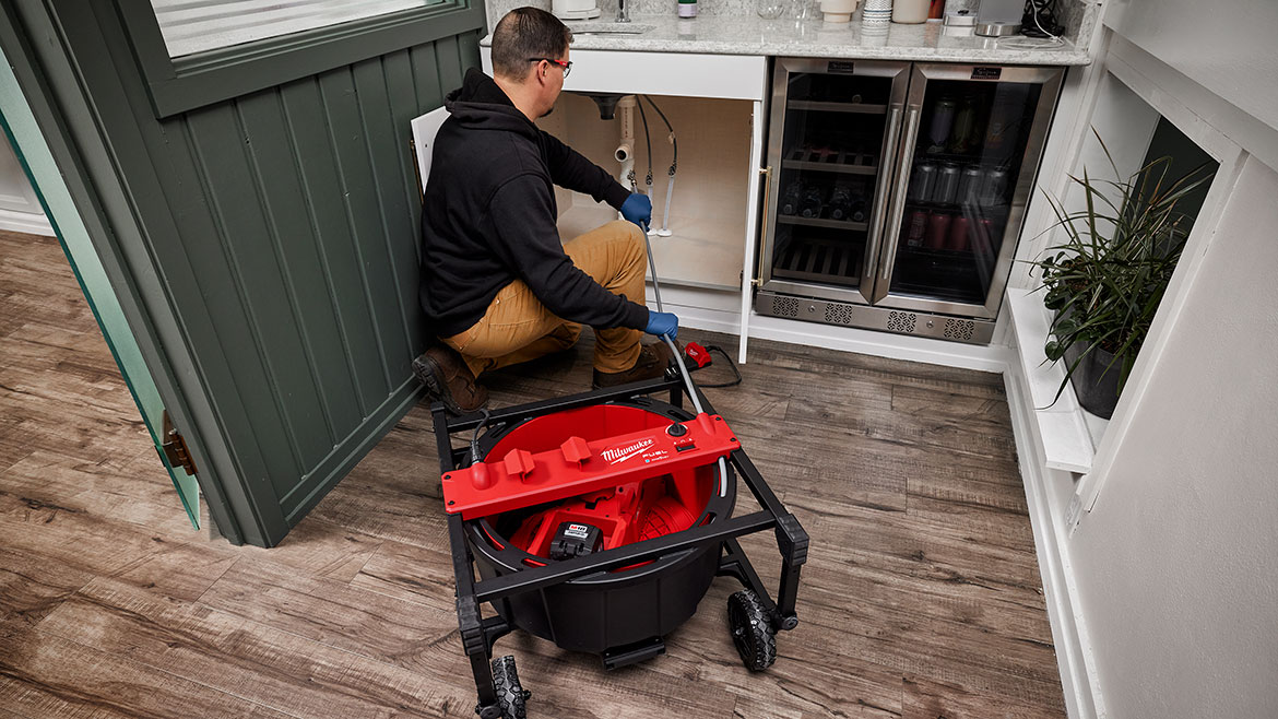 Milwaukee’s M18 FUEL Chain Snake provides the power to descale up to 75’ out delivering full power at max distance. Here, it's being used in a wetbar setting underneath the sink.