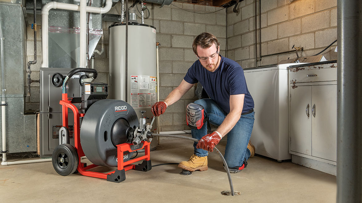 The RIDGID K-4310 FXP Drum Machine being used in a basement drain.