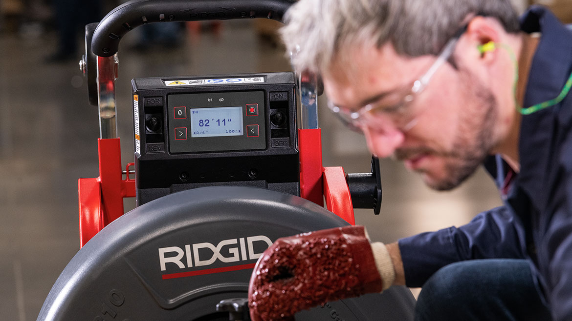 The RIDGID K-4310 FXP Drum Machine being used by a plumber.