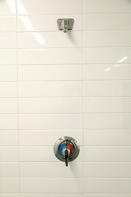 Close-up of gym locker room shower handle