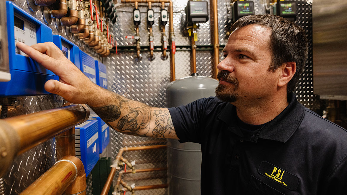 Brandon Content, PSI outside sales and system designer, changes control parameters on a tekmar system.