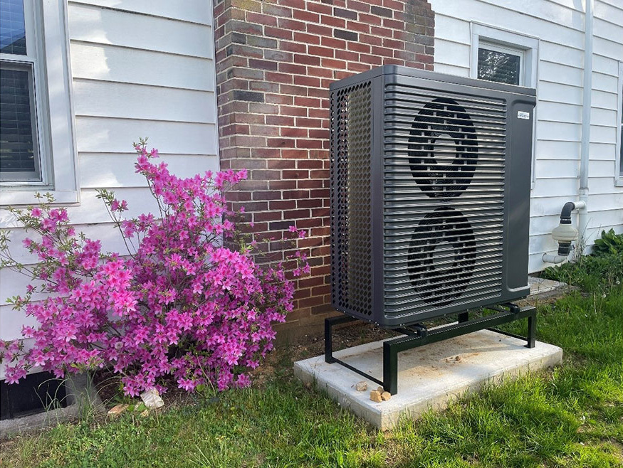 Air-to-Water Heat Pump installed outdoors on a metal stand.