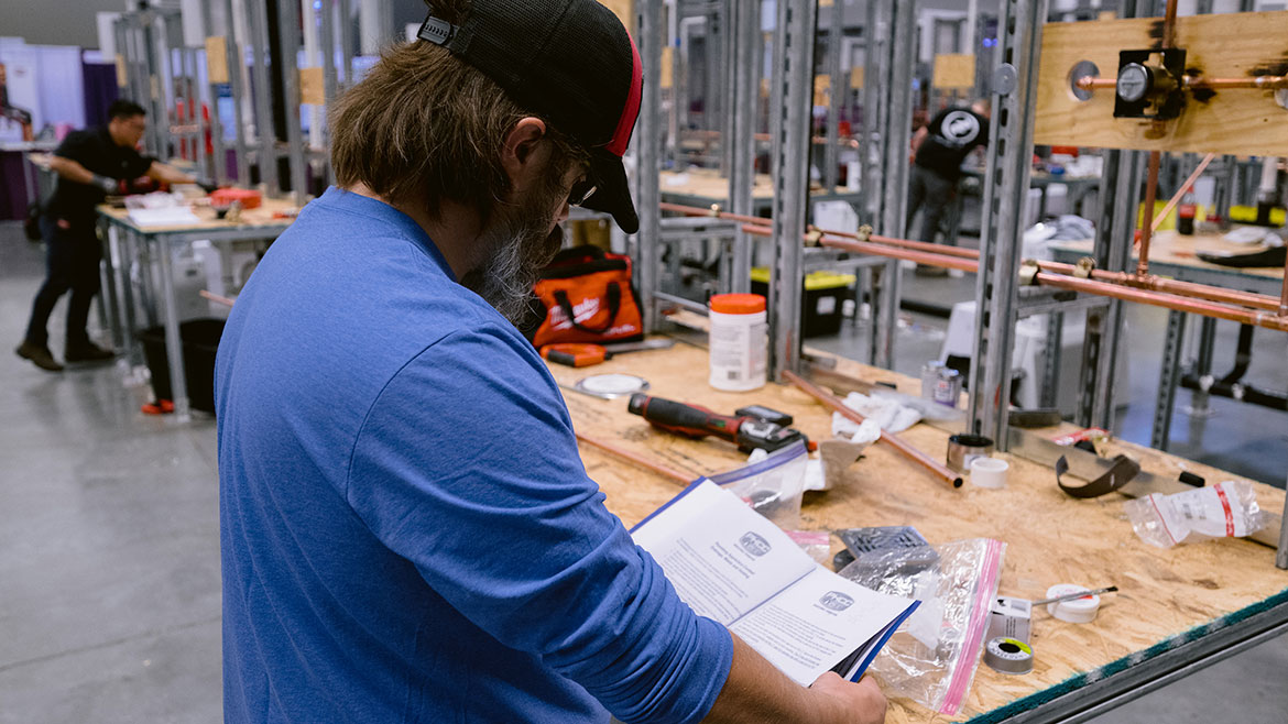 Apprentice reading a manual.