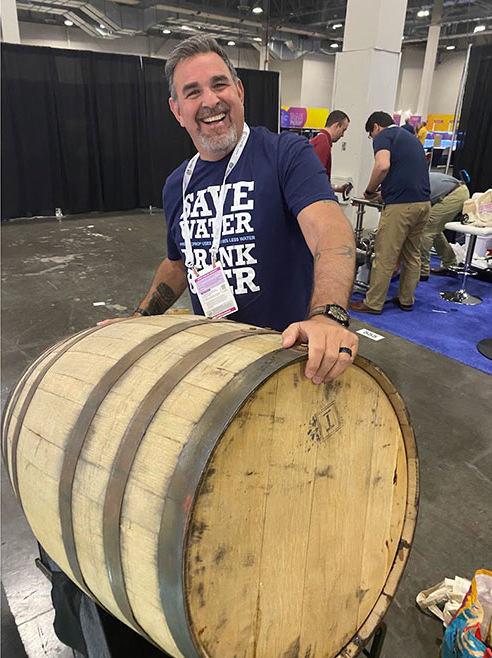 Scott Steindler holding an oak barrel.