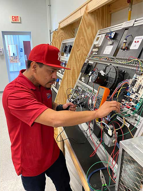 Daniel Segundo, a student at PPATEC, is shown working in the lab.