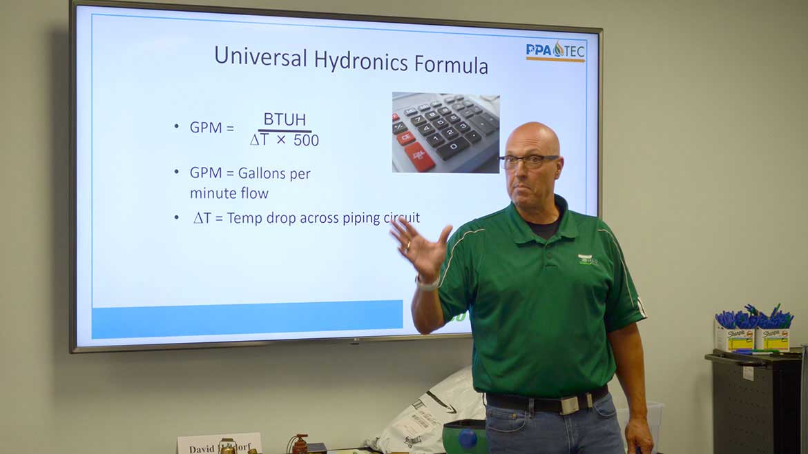 Instructor, Dave Holdorf teaching a class at PPATEC, standing in front of a large monitor.