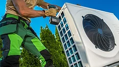 HVAC Technician Installing Large Modern Heat Pump