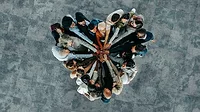 Top view of a a heart shape of people, showing unity and teamwork Top view of a a heart shape of people, showing unity and teamwork.