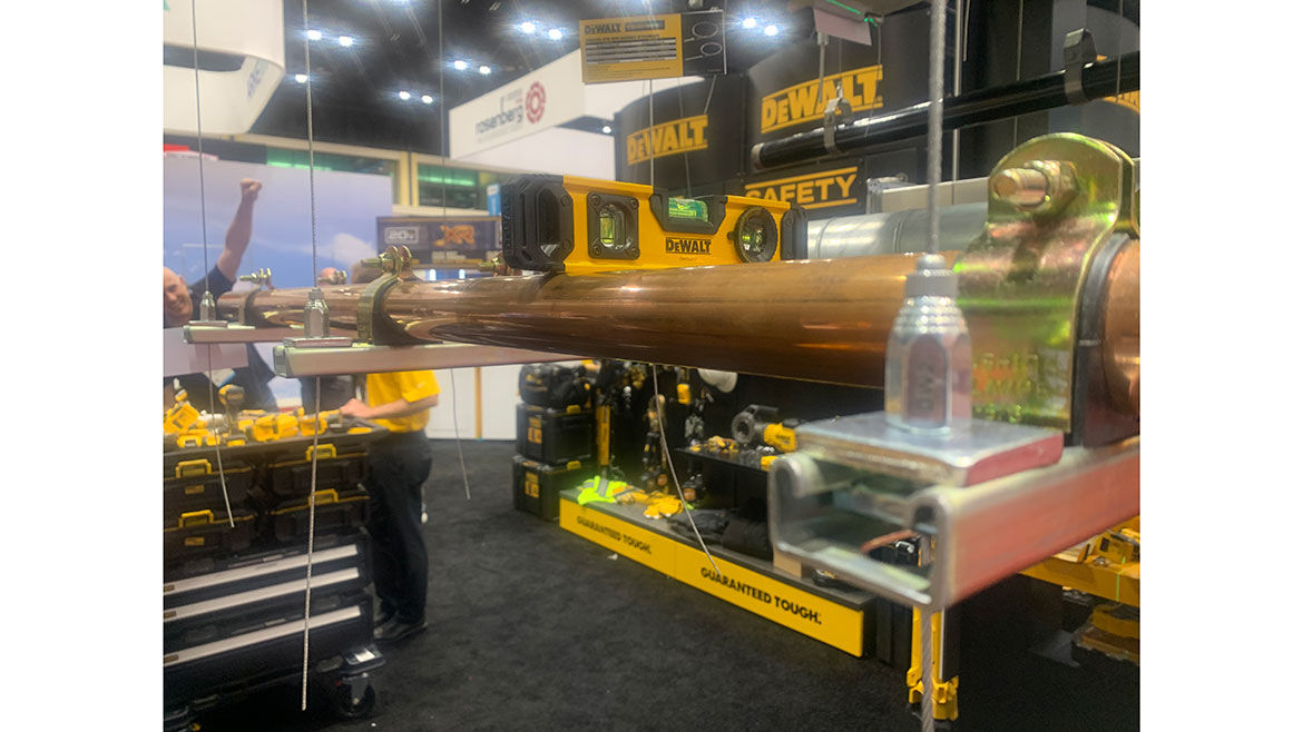 DeWALT booth adjustable Toughwire cable support system for HVAC ducts and plumbing piping in a hands-on display.