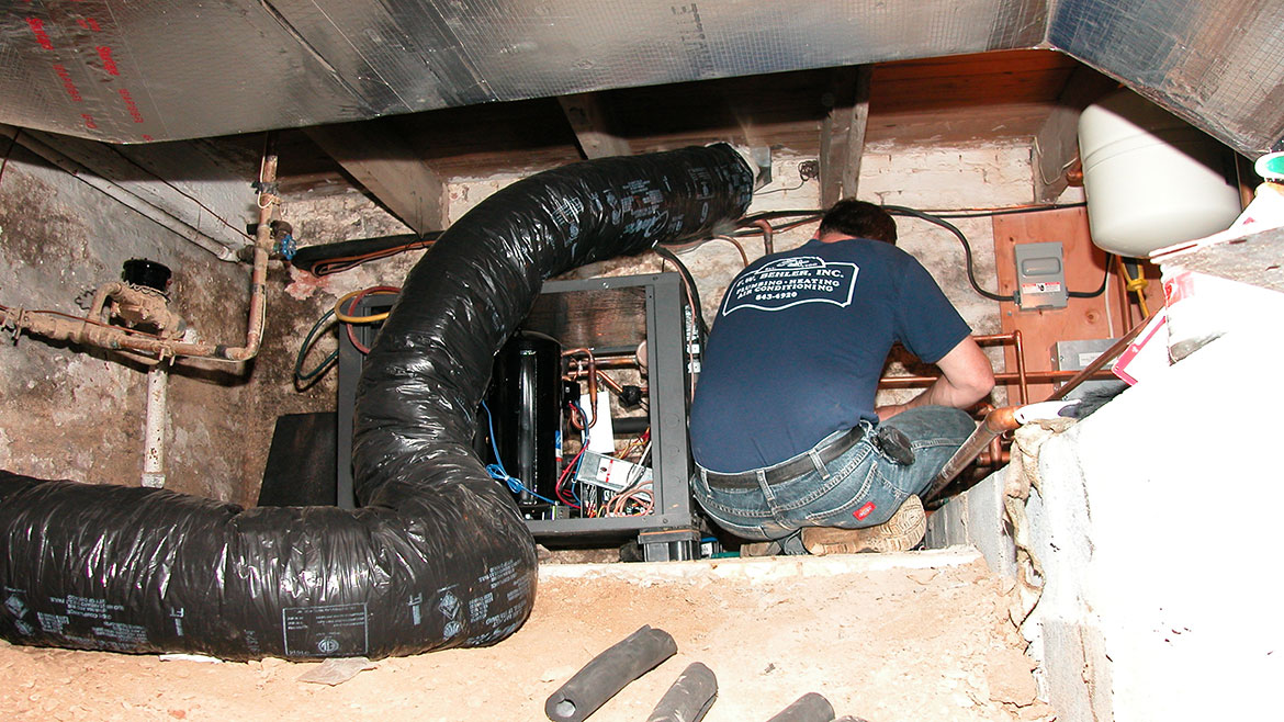 Working in a basement crawl space.