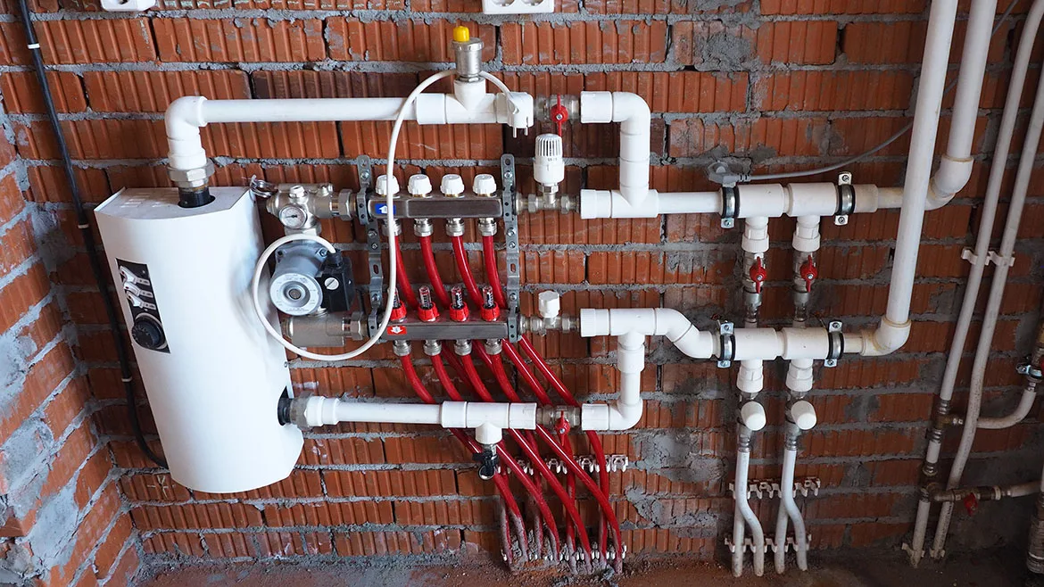 Integrate a heat pump with a boiler mounted on a brick wall.