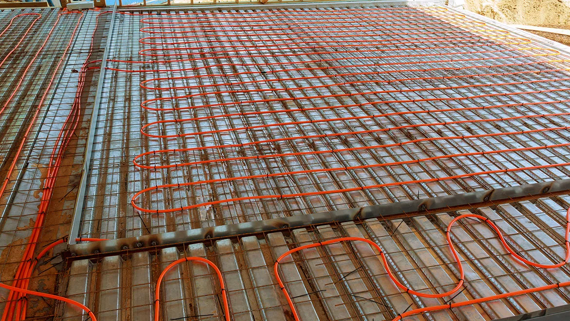 Modern manual laying of tuning water hydronic gas firing conduit supply on metal mesh insulation indoor new house room.