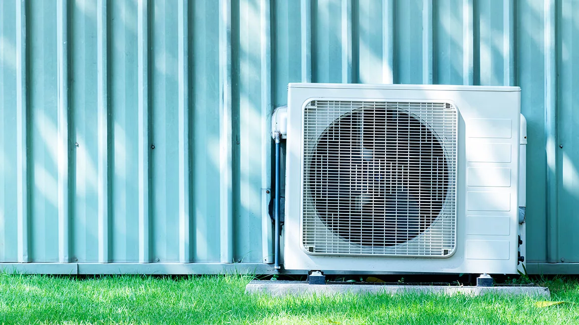 Compressors air conditioners on grass field.