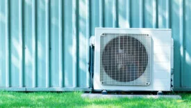 Compressors air conditioners on grass field.
