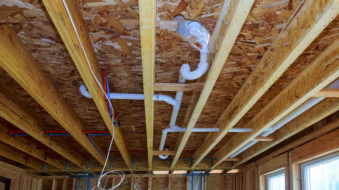 Waste PVC pipe drainage system inside building, piping on the ceiling of home.