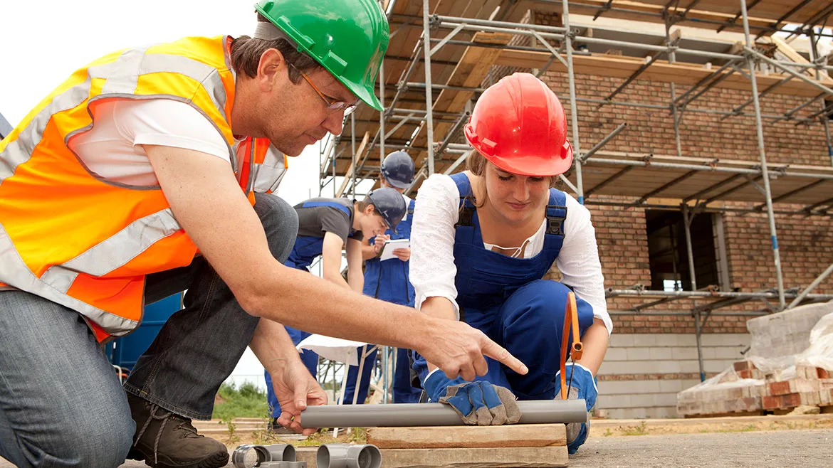 Plumbing student receiving on-site instructions.