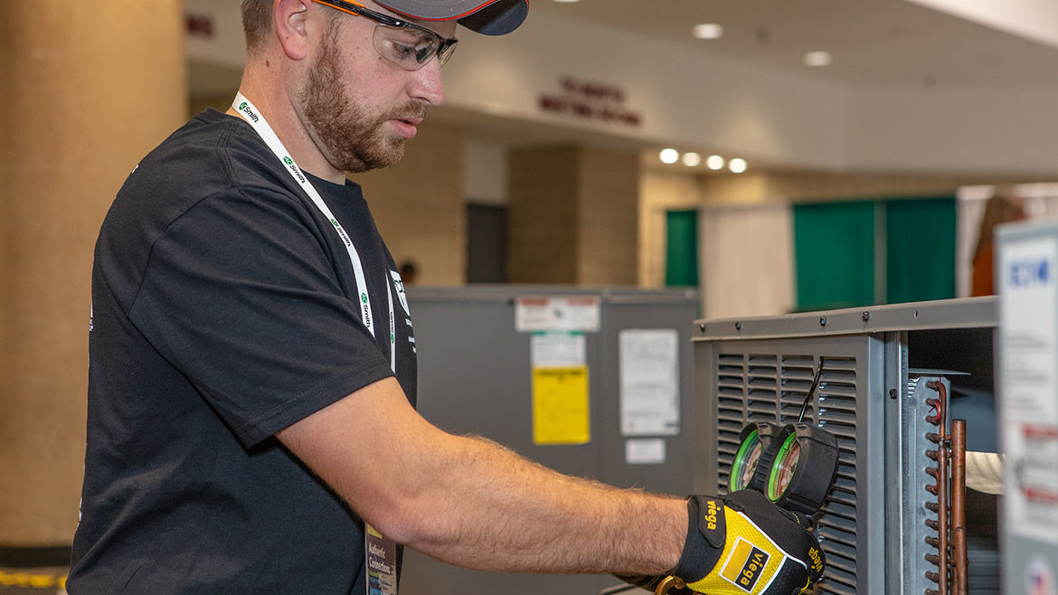 An HVAC apprentice working during the 2024 PHCC Connect skills competition.
