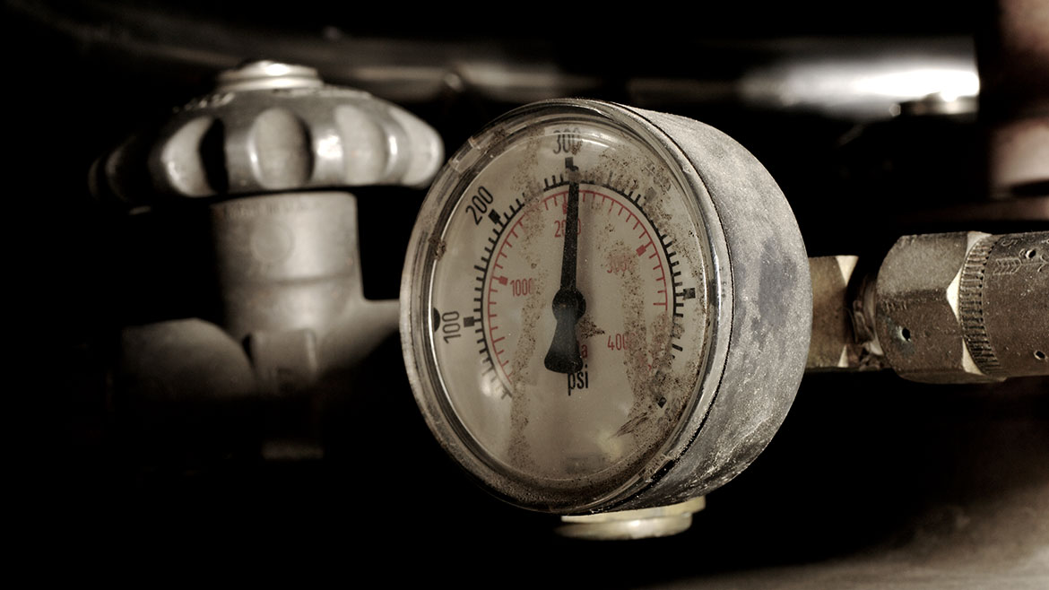 Industrial pressure gauge on a tank.