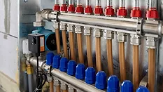 Floor heating manifold cabinet with flowmeter and PEX pipe.